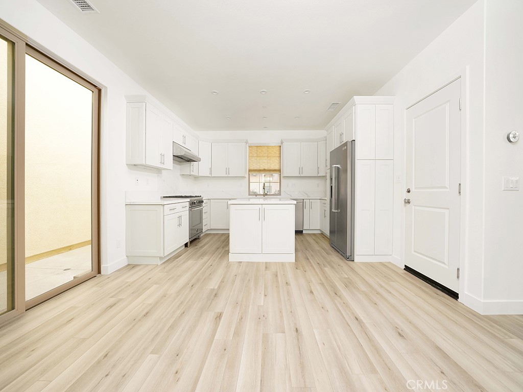 120 Messenger Irvine, CA 92618 - Photo 2 of 26 a view of a kitchen with wooden floor electronic appliances and window