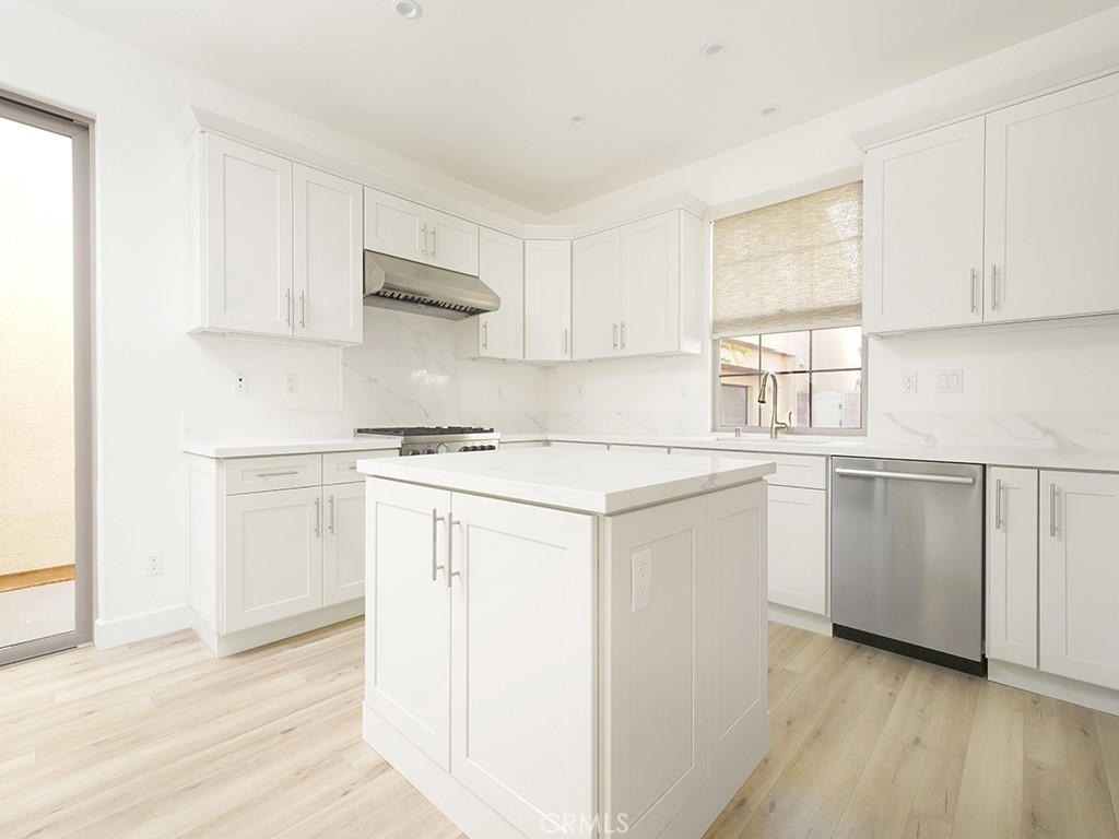 120 Messenger Irvine, CA 92618 - Photo 3 of 26 a kitchen with white cabinets and white appliances