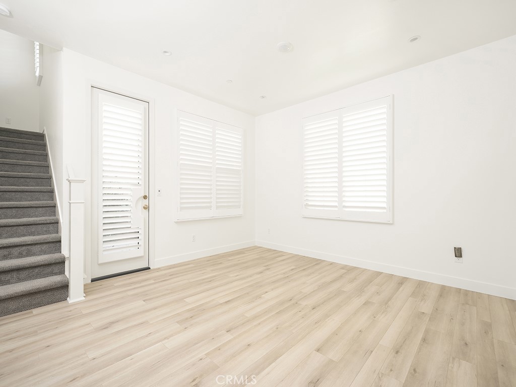 120 Messenger Irvine, CA 92618 - Photo 8 of 26 an empty room with wooden floor and windows