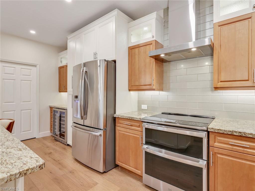 5242 Kensington High Street Naples, FL 34105 - Photo 14 of 45 Built in double oven, hood, refrigerator and beverage cooler.