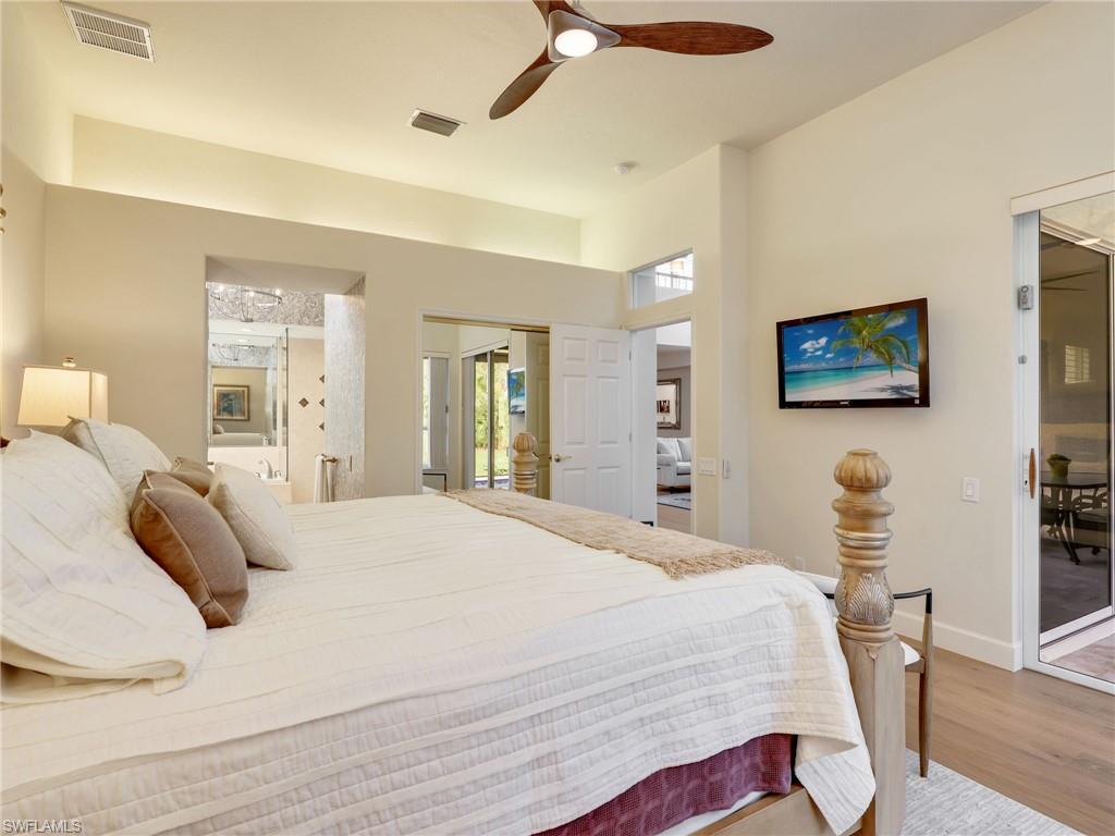 5242 Kensington High Street Naples, FL 34105 - Photo 26 of 45 The Primary Bedroom has access to lanai for a late swim or spa