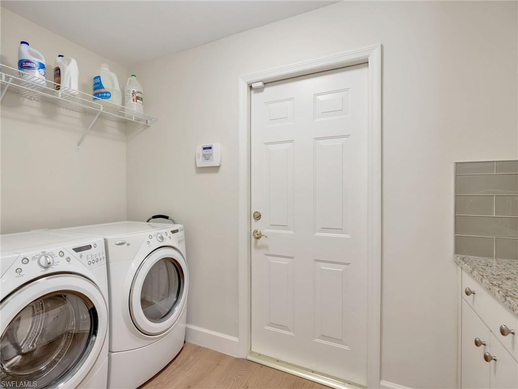5242 Kensington High Street Naples, FL 34105 - Photo 40 of 45 The laundry is accessible from the kitchen with entry to the garage