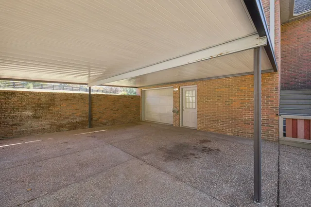 a view of a patio with chairs and a table