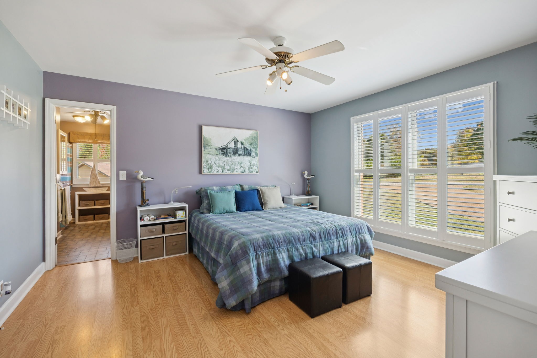 7875 Oscar Green Road Primm Springs, TN 38476 - Photo 8 of 44 a bedroom with a large bed a chandelier and windows