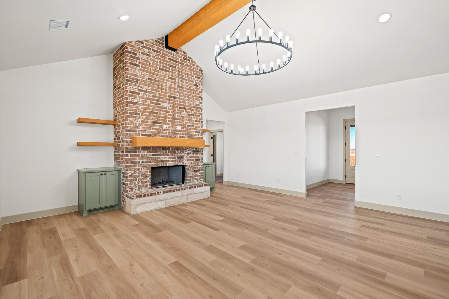 8412 North County Road 1300 Shallowater, TX 79363 - Photo 23 of 43 a view of an empty room with a fireplace and kitchen view