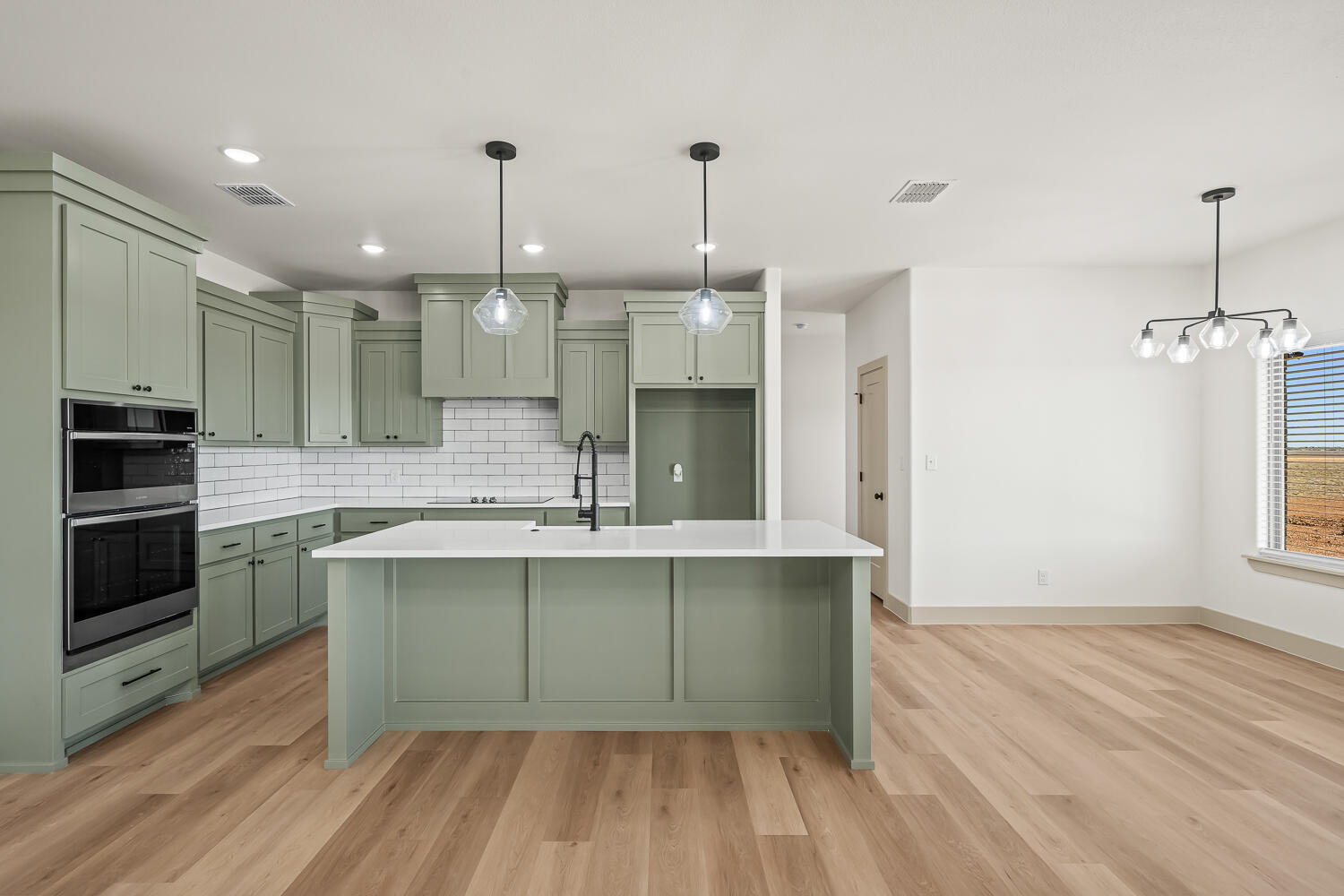 8412 North County Road 1300 Shallowater, TX 79363 - Photo 26 of 43 a large kitchen with kitchen island a sink stainless steel appliances and cabinets
