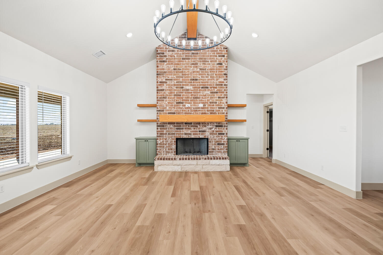 8412 North County Road 1300 Shallowater, TX 79363 - Photo 27 of 43 a view of an empty room with a fireplace and a window