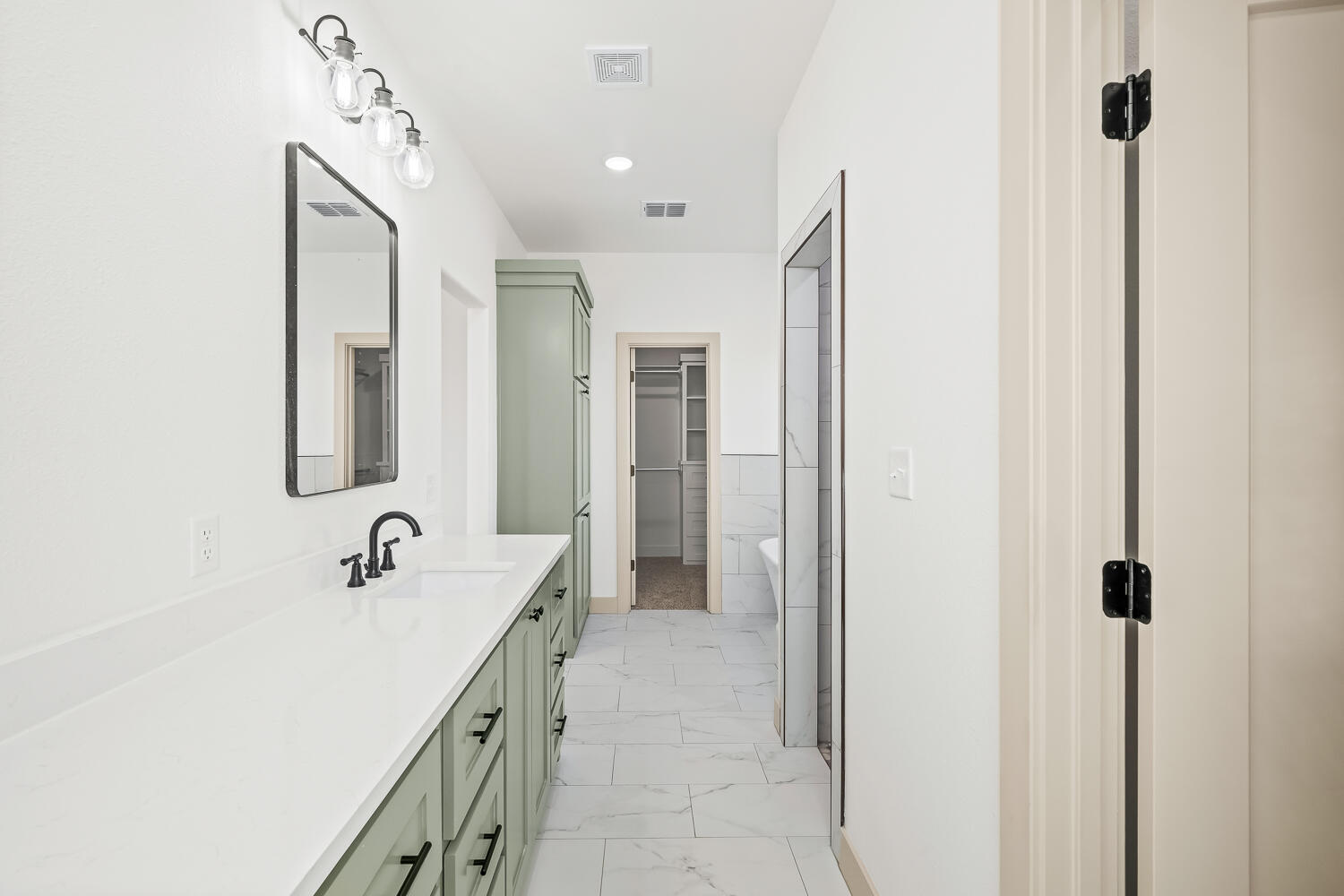 8412 North County Road 1300 Shallowater, TX 79363 - Photo 6 of 43 a bathroom with a double vanity sink a mirror and a shower