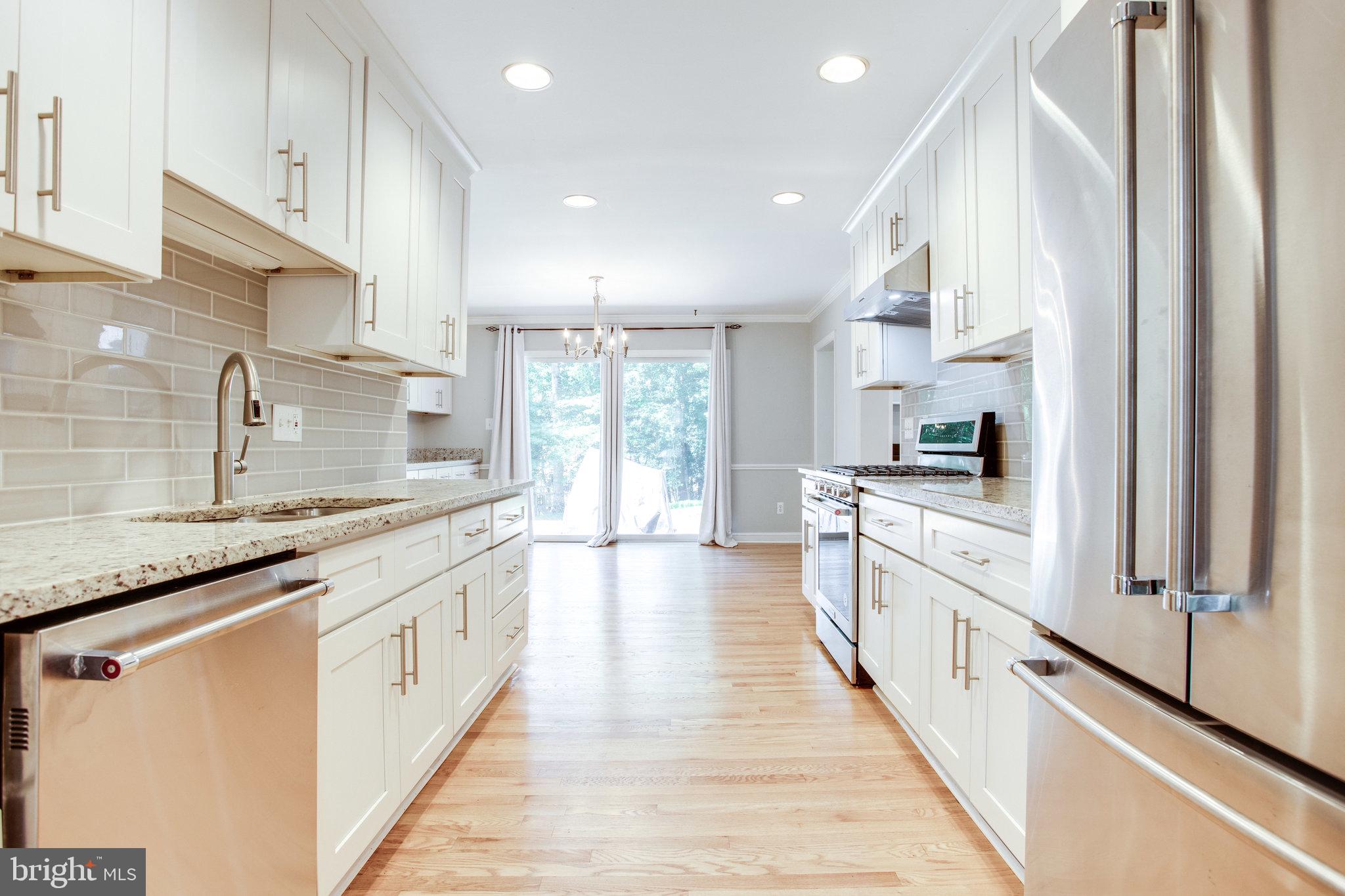 8500 Brook Road McLean, VA 22102 - Photo 15 of 44 a large kitchen with stainless steel appliances kitchen island granite countertop a large counter top and a stove