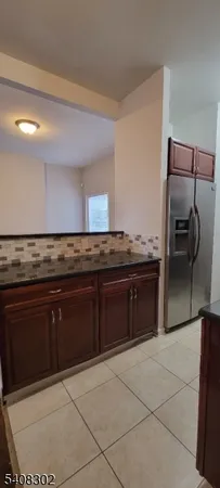 a kitchen with granite countertop a cabinets and steel stainless steel appliances