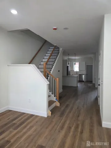 a view of entryway and hall with wooden floor