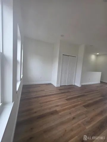 a view of wooden floor and windows in a room