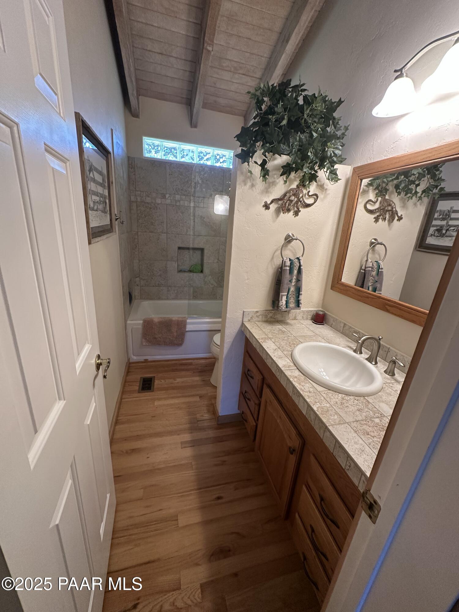 13502 South Burton Road Mayer, AZ 86333 - Photo 37 of 46 a bathroom with a granite countertop sink a mirror and shower
