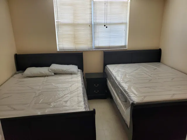 a bedroom with bed and window