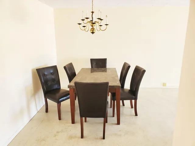 a view of a dining room with furniture and a chandelier