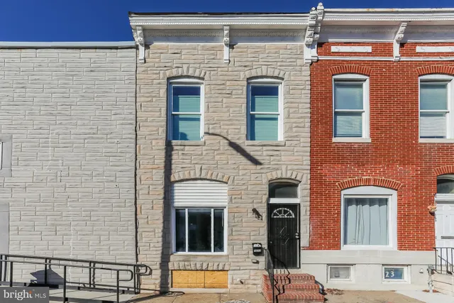 a front view of a house with many windows