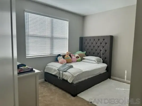 a bedroom with a bed and window