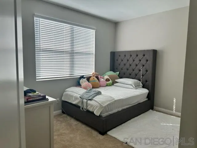 1767 Whitmore Loop Chula Vista, CA 91913 - Photo 14 of 22 a bedroom with a bed and window
