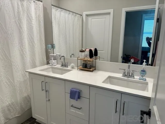 1767 Whitmore Loop Chula Vista, CA 91913 - Photo 16 of 22 a bathroom with a double vanity sink and a mirror