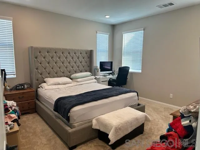 1767 Whitmore Loop Chula Vista, CA 91913 - Photo 19 of 22 a bedroom with bed and window