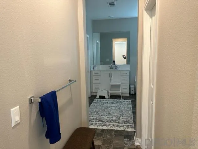 1767 Whitmore Loop Chula Vista, CA 91913 - Photo 20 of 22 a bathroom with a shower and a mirror