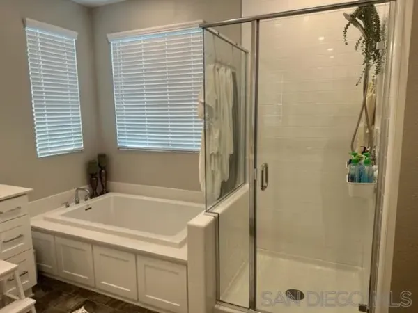 a bathroom with a bathtub and a shower