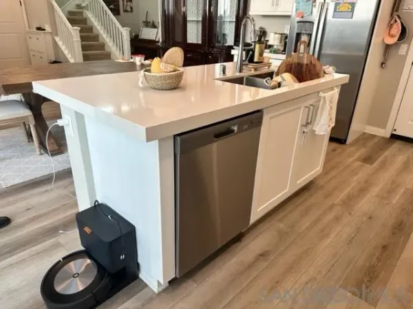 a kitchen with a sink a stove and cabinets