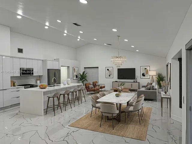 a living room with furniture a flat screen tv and a table