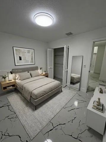 a bedroom with a bed and a couch
