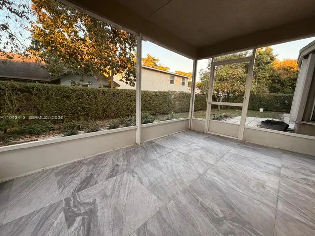 a view of empty room with floor to ceiling window