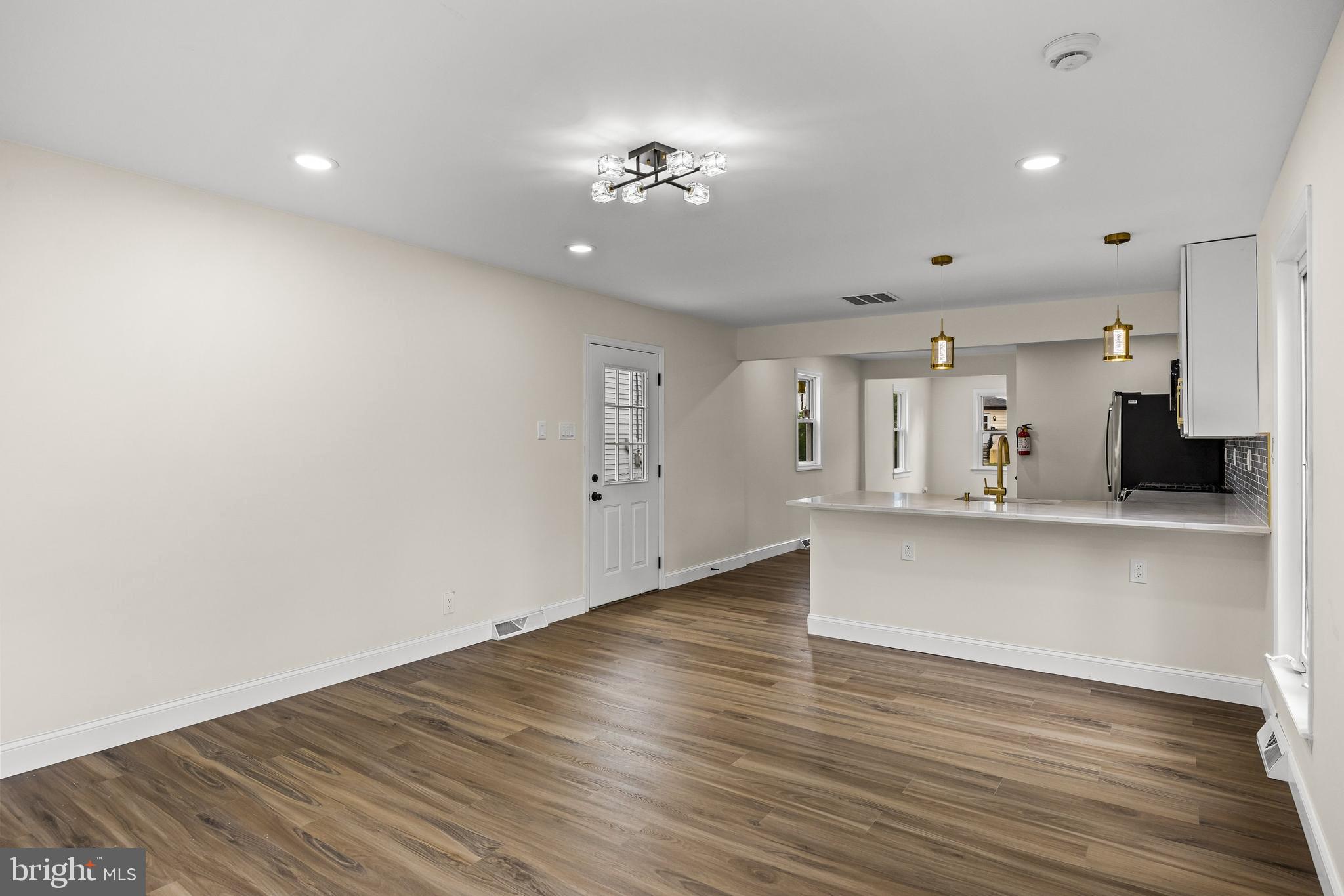 937 Clements Bridge Road Barrington, NJ 08007 - Photo 17 of 34 a view of a living room a kitchen with wooden floor and a kitchen