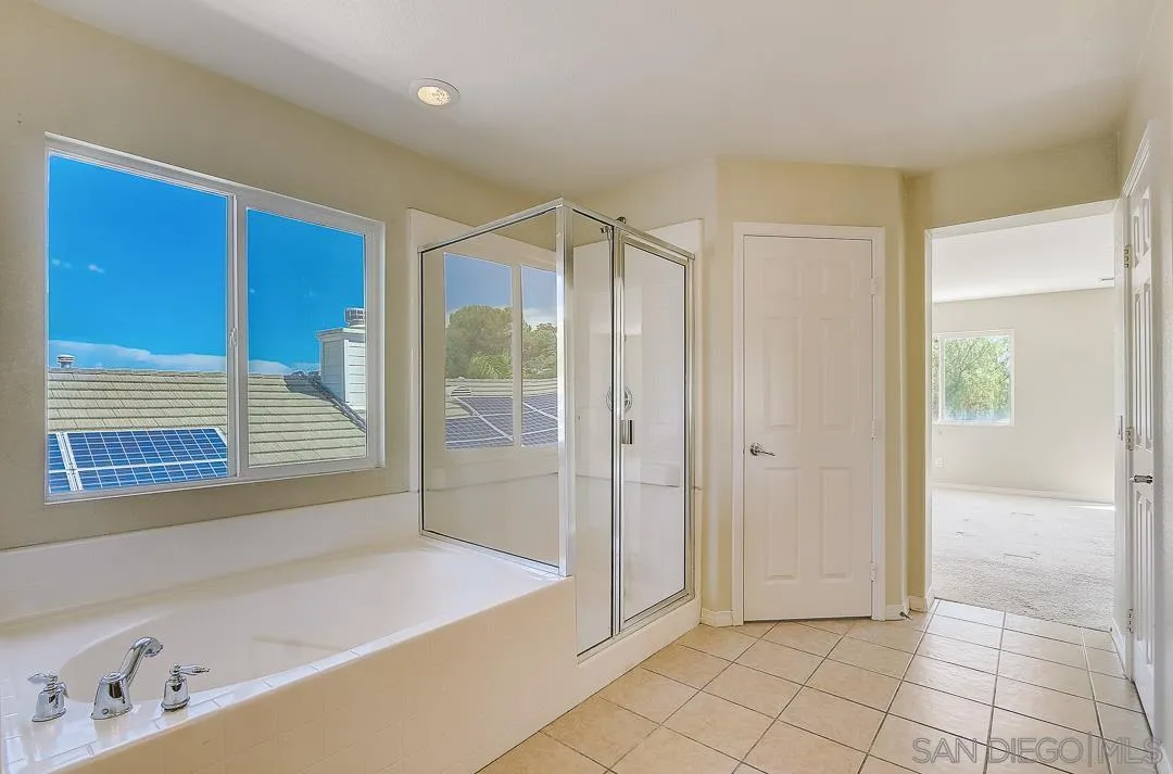 551 Dundee Lane San Marcos, CA 92069 - Photo 22 of 30 a bathroom with a tub shower and a sink