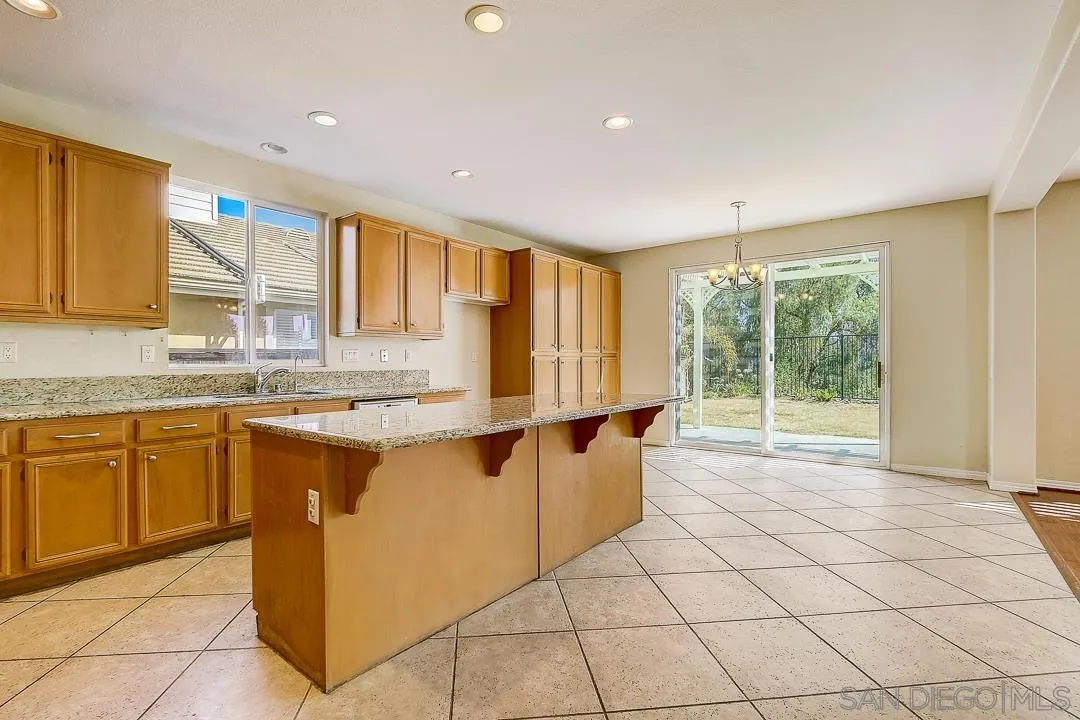 551 Dundee Lane San Marcos, CA 92069 - Photo 30 of 30 a kitchen with stainless steel appliances granite countertop a stove a sink and a refrigerator