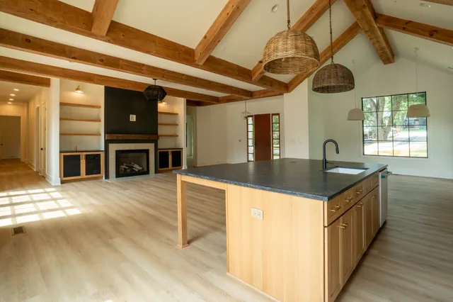 a kitchen with stainless steel appliances granite countertop a sink a counter space and cabinets