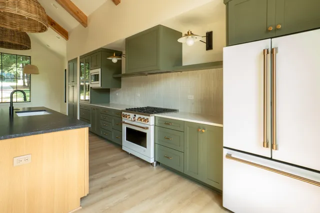 a kitchen with a refrigerator and a sink