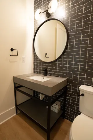 a bathroom with a toilet a sink and mirror