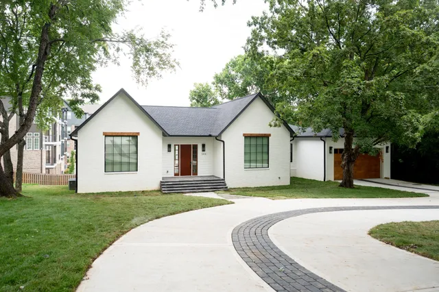 a front view of house with yard and green space