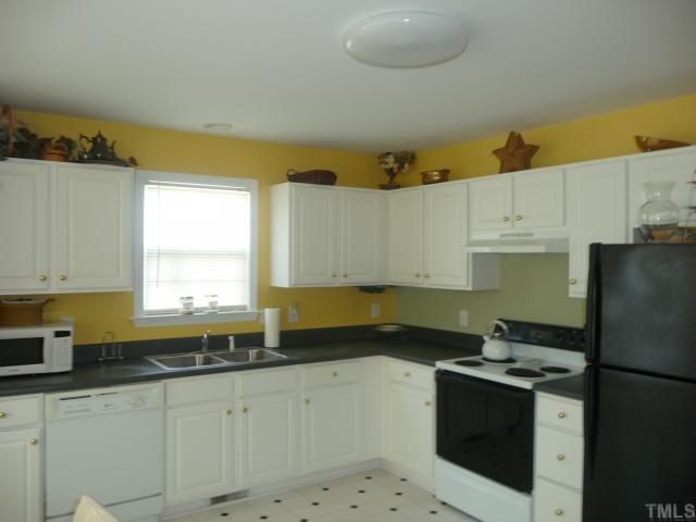 10405 Perry Ridge Court Zebulon, NC 27597 - Photo 3 of 10 Bright and Sunny Kitchen, with smooth surface counter tops, and tons of counter and cabinet space