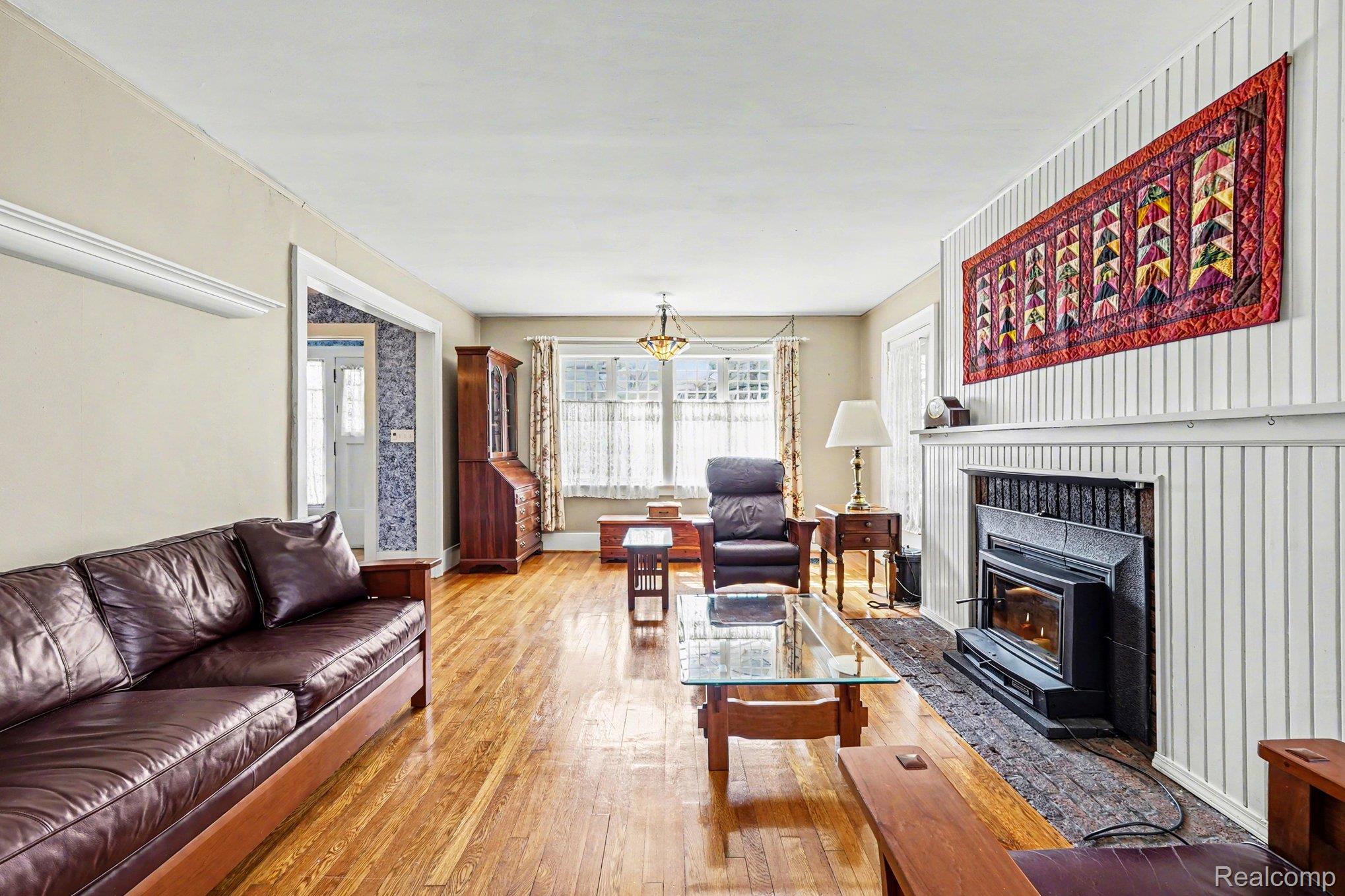 1235 Yorkshire Road Birmingham, MI 48009 - Photo 11 of 36 Living room featuring Oak hardwood flooring and a wood burning fireplace with Hearthstone insert