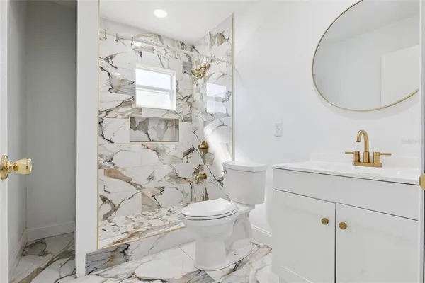 a bathroom with a sink toilet and shower