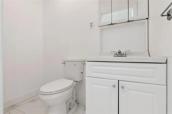 a bathroom with a sink a toilet and vanity