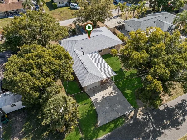 an aerial view of a house with a yard