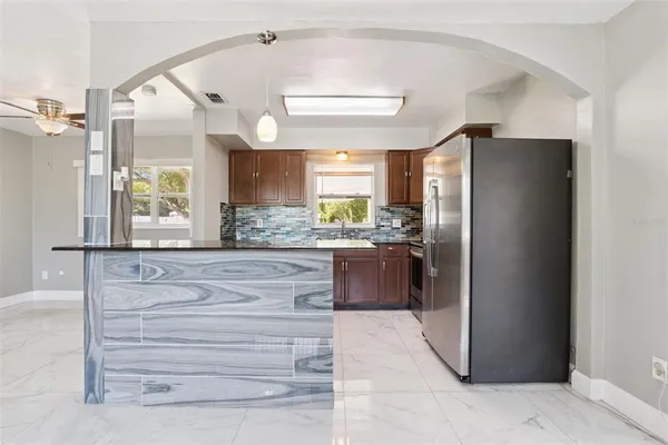 a kitchen with a refrigerator and a sink