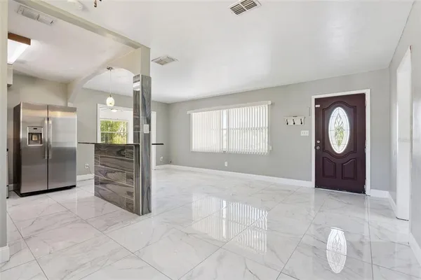an empty room with windows and entrance