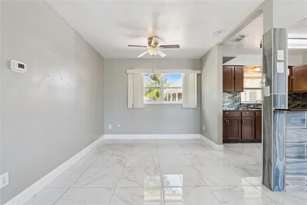 a view of a kitchen with a sink dishwasher a refrigerator and a stove top oven