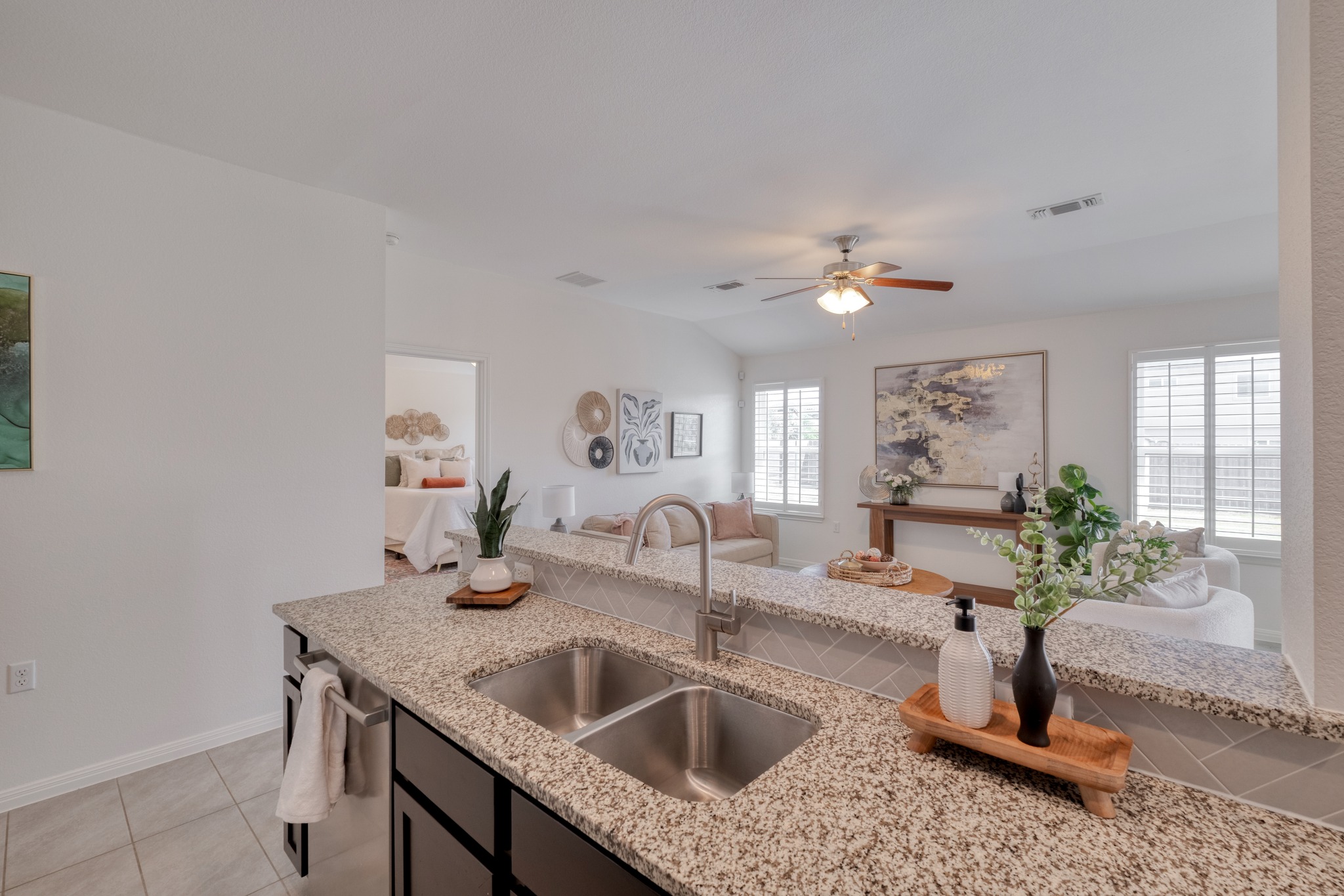 16400 Fetching Avenue Manor, TX 78653 - Photo 32 of 32 Kitchen featuring light tile patterned floors, a ceiling fan, open floor plan, light stone countertops, and dishwasher