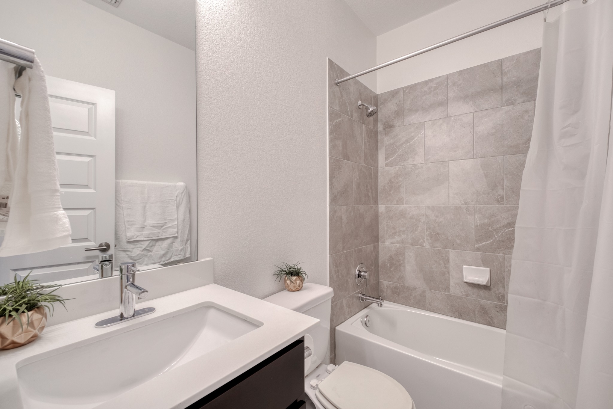 16400 Fetching Avenue Manor, TX 78653 - Photo 17 of 32 Bathroom featuring a textured wall, vanity, and shower / bath combination with curtain