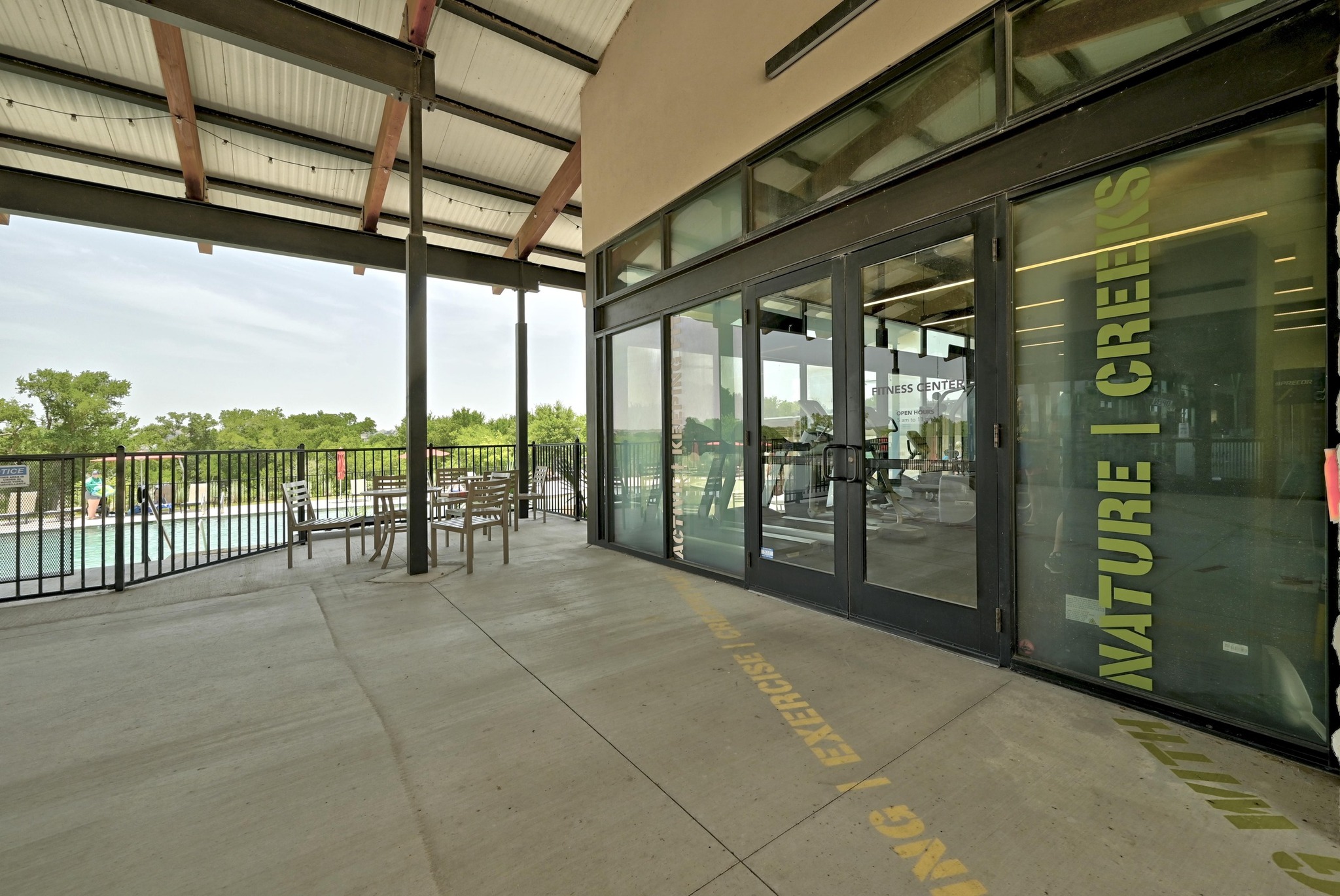 16400 Fetching Avenue Manor, TX 78653 - Photo 25 of 32 Property entrance featuring french doors, a community pool, and a patio