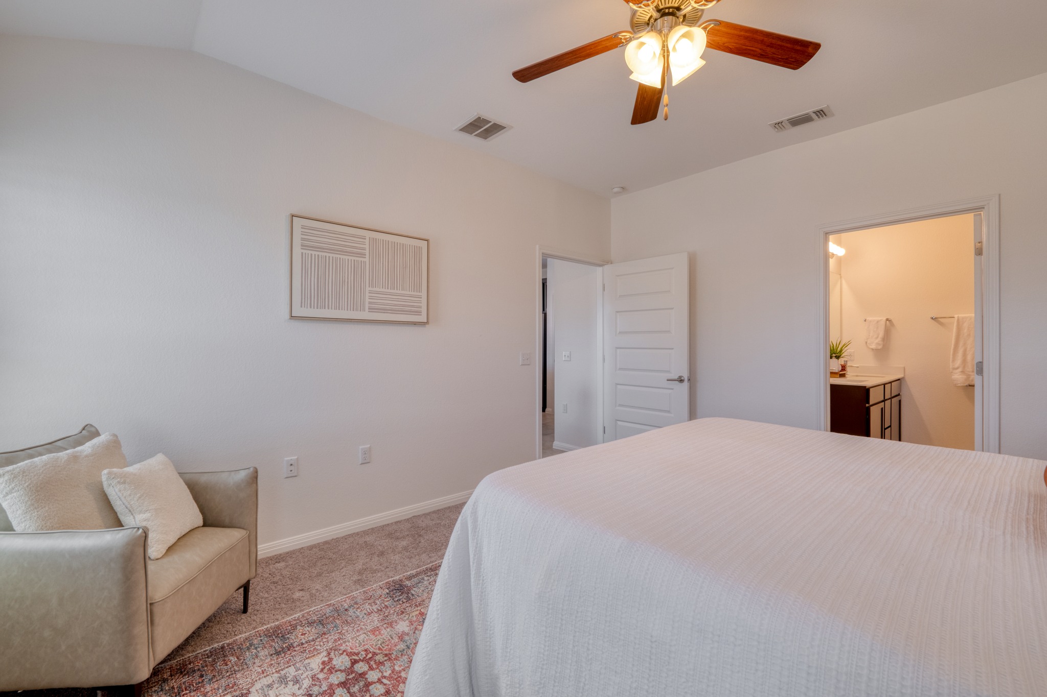 16400 Fetching Avenue Manor, TX 78653 - Photo 9 of 32 Bedroom with light colored carpet, ceiling fan, and connected bathroom