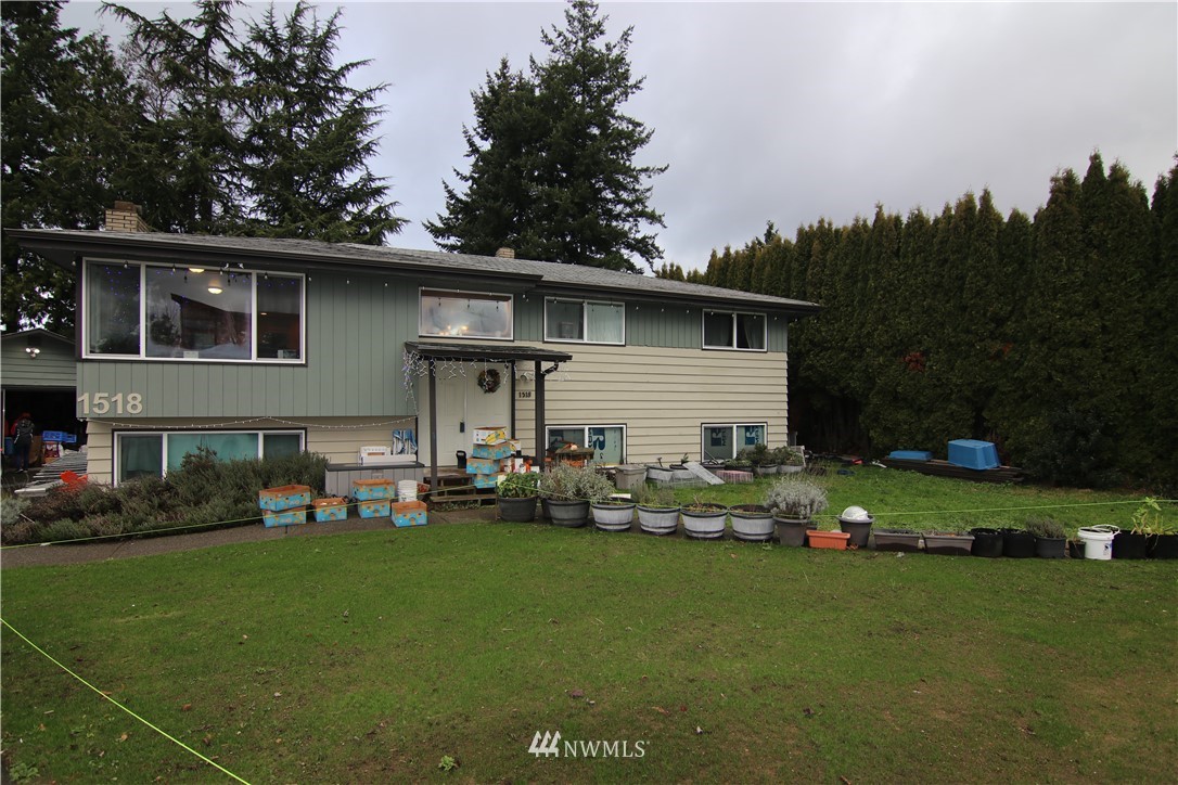 a front view of house with outdoor seating and yard